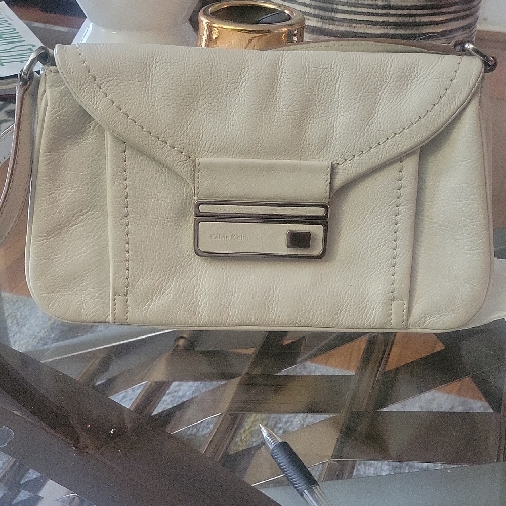 Calvin Klein Cream Leather Purch Silver Buckle.  11X6. Small Ink mark Inside.